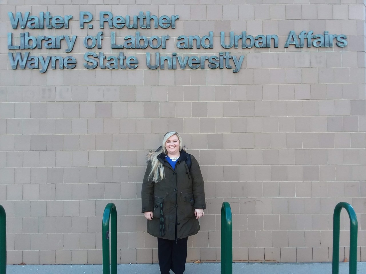 Ashley Cabala standing in front of WSU's Walter P. Reuther Library